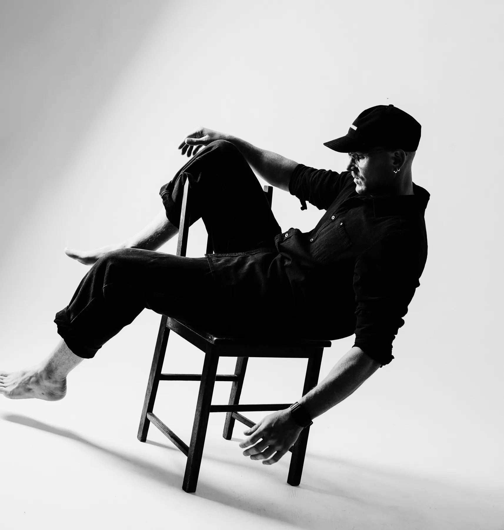Calum Shand leaning back on a wooden chair