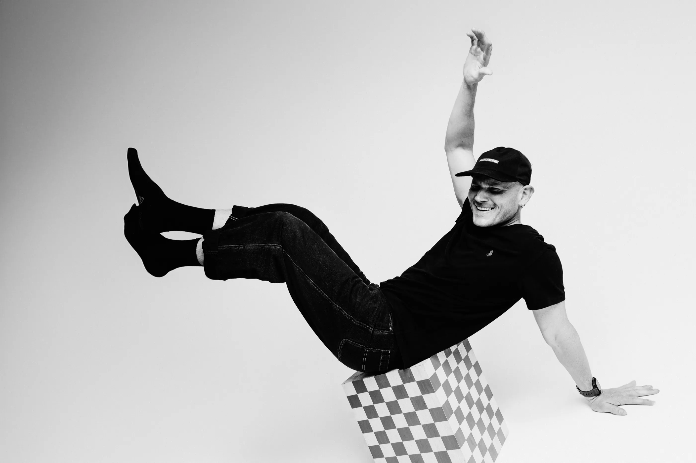 Calum Shand laughing, legs kicked up, leaning back