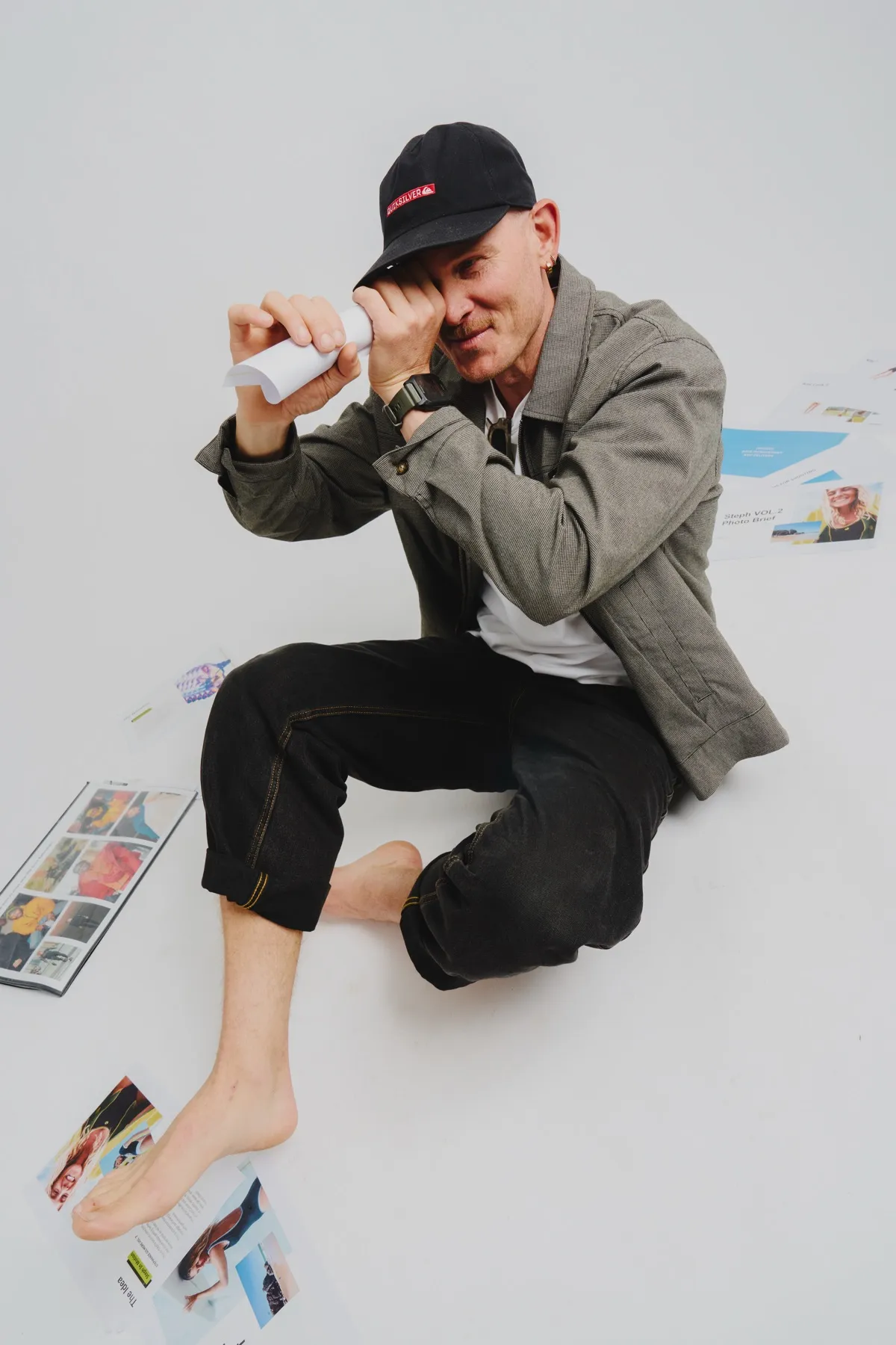Calum peering through a rolled-up telescope of paper
